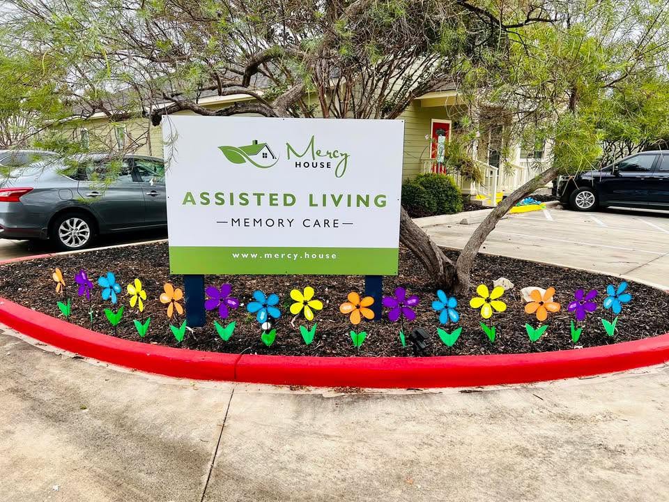 Mercy House sign New Braunfels with Flowers in Texas